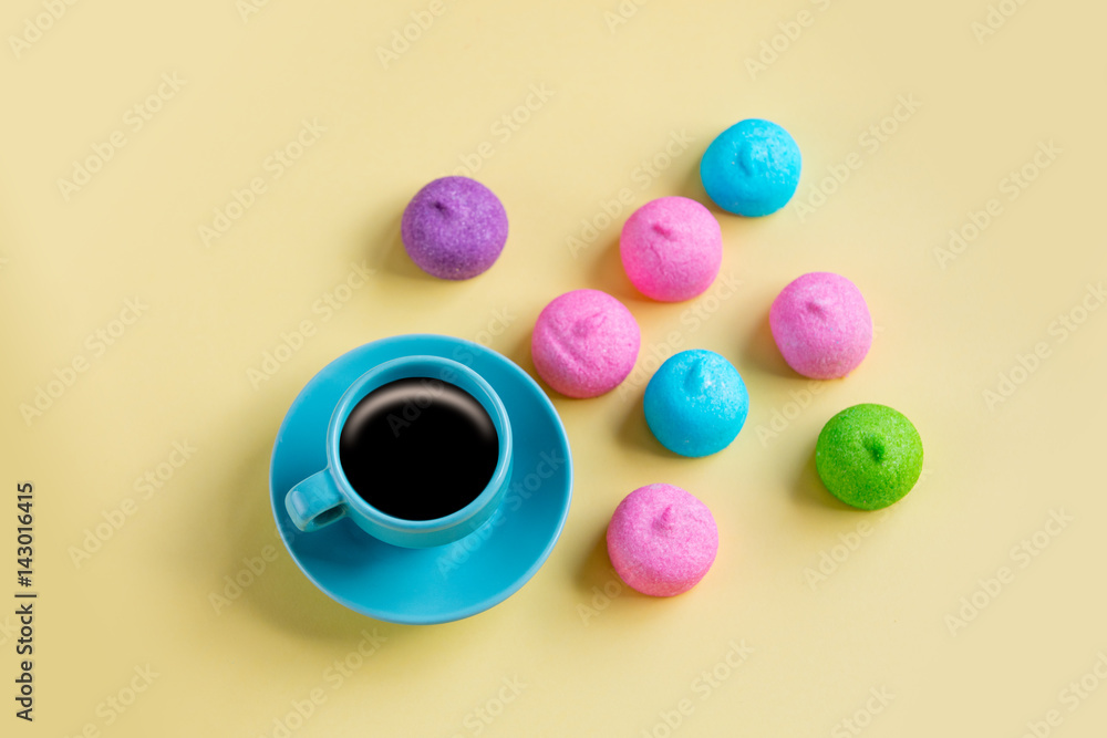 photo of tasty colorful marshmallows and cup of coffee on the wonderful yellow background photo of tasty colorful marshmallows and cup of coffee on the wonderful yellow background