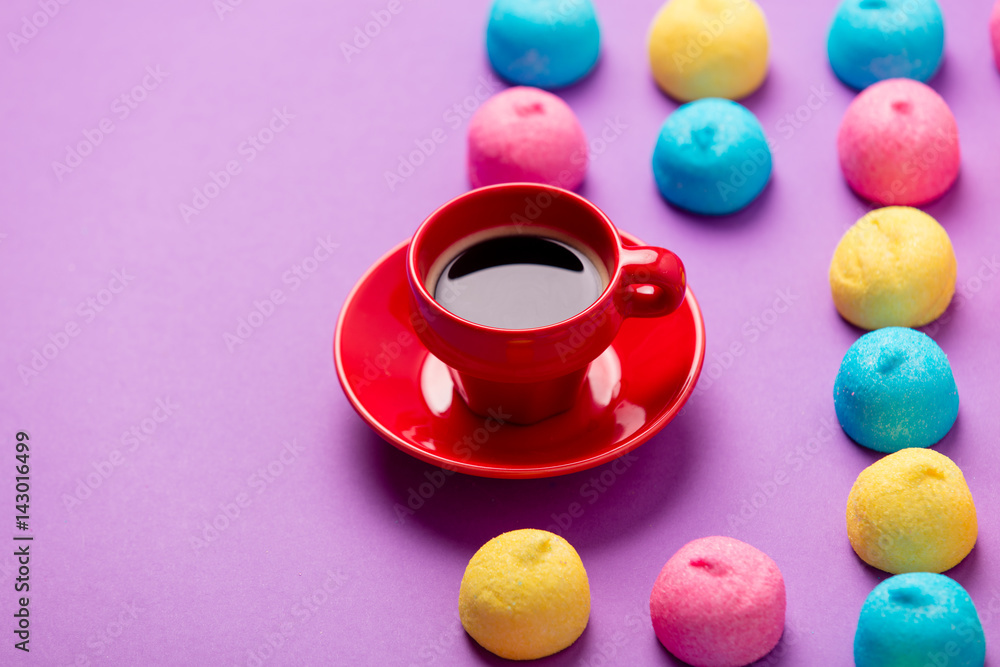 photo of tasty colorful marshmallows and cup of coffee on the wonderful purple background photo of tasty colorful marshmallows and cup of coffee on the wonderful purple background