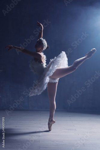 Young beautiful ballerina dancing in studio