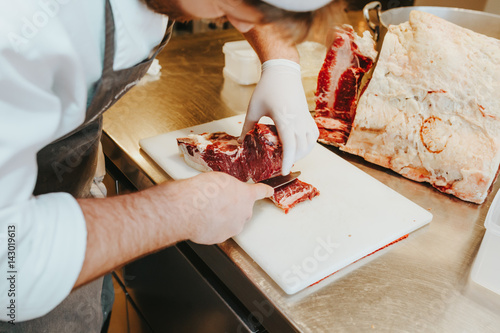 A person cutting the meat photo