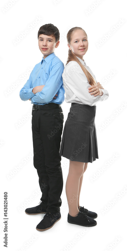 Cute boy and girl in school uniform standing on white background