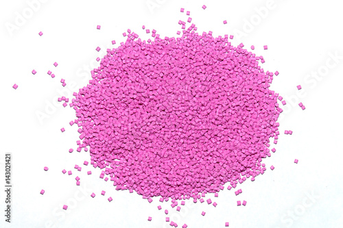 Polymeric dye for plastics. Pigment in the granules on a light background.  photo