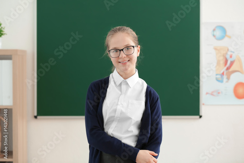 Cute girl standing near gre...