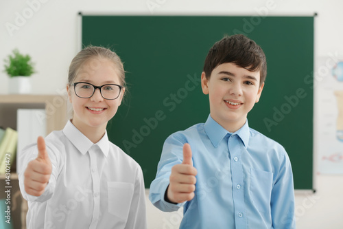 Cute boy and girl standing ...