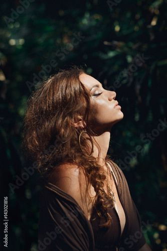 sensitive portrait of beautiful young woman in forest
