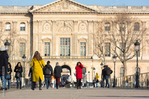 Fototapeta Naklejka Na Ścianę i Meble -  People of Paris and tourists  walking on the streets surrounded with historical buildings and landmarks