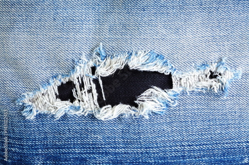 Blue denim jeans present the old denim look and old damaging fabric that shown detail of texture background. 
