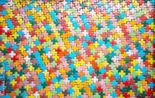 Colorful plus shape brick on wall : Closeup photo
