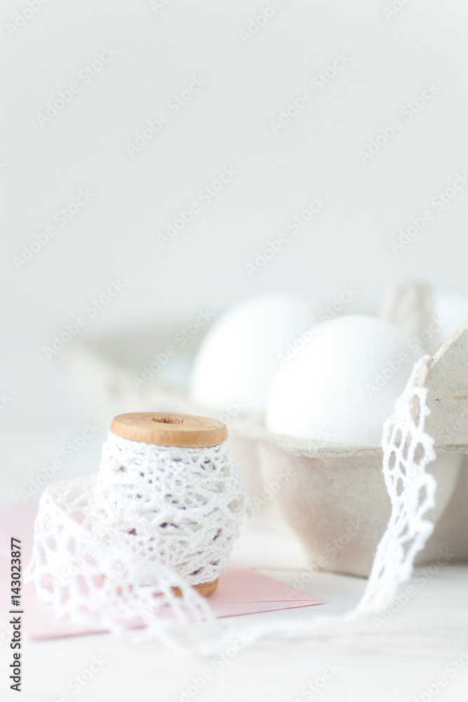 Easter eggs on white wooden background with pink envelope Easter eggs on white wooden background with pink envelope