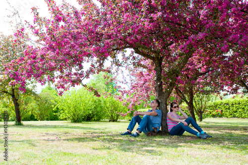 Summer is coming to the city - family resting under tree