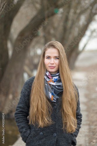 Portrait of a beautiful girl in early spring on the road. © makam1969