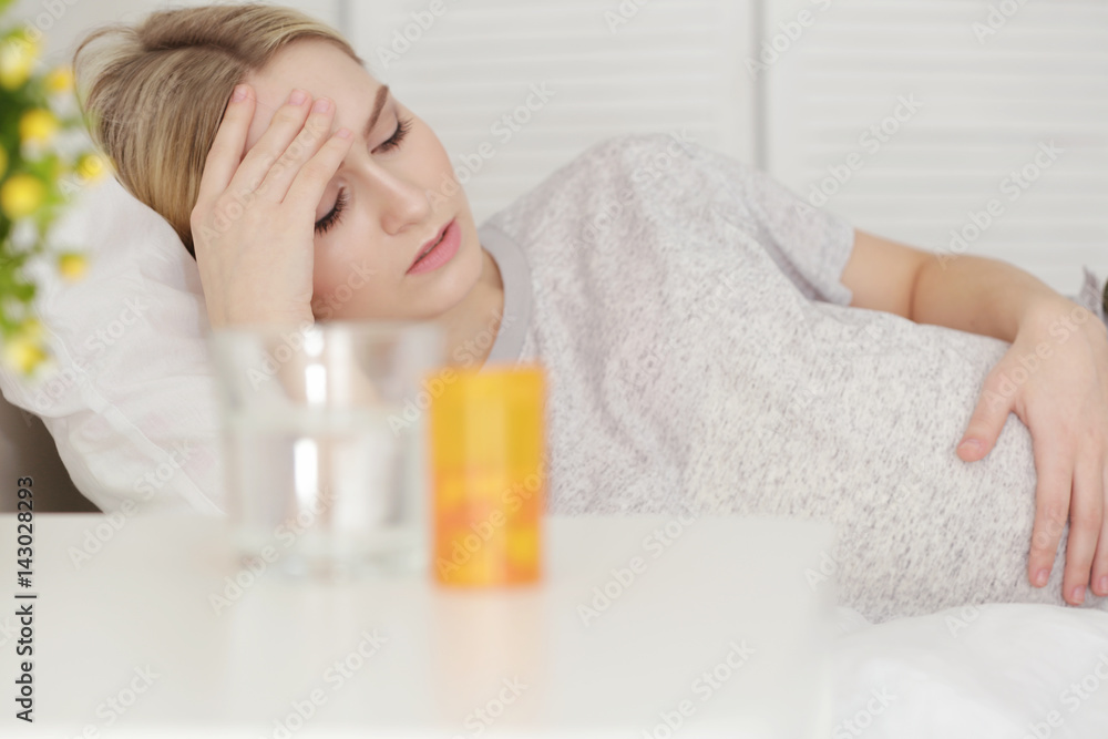 Young pregnant woman suffering from headache at home Young pregnant woman suffering from headache at home