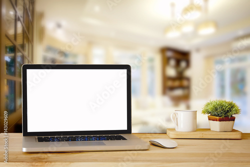 Mock up Blank screen laptop on wood top table and blurred living room background. for Procuct display montage. photo