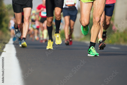 Fototapeta Naklejka Na Ścianę i Meble -  Marathon running race, runners feet on road