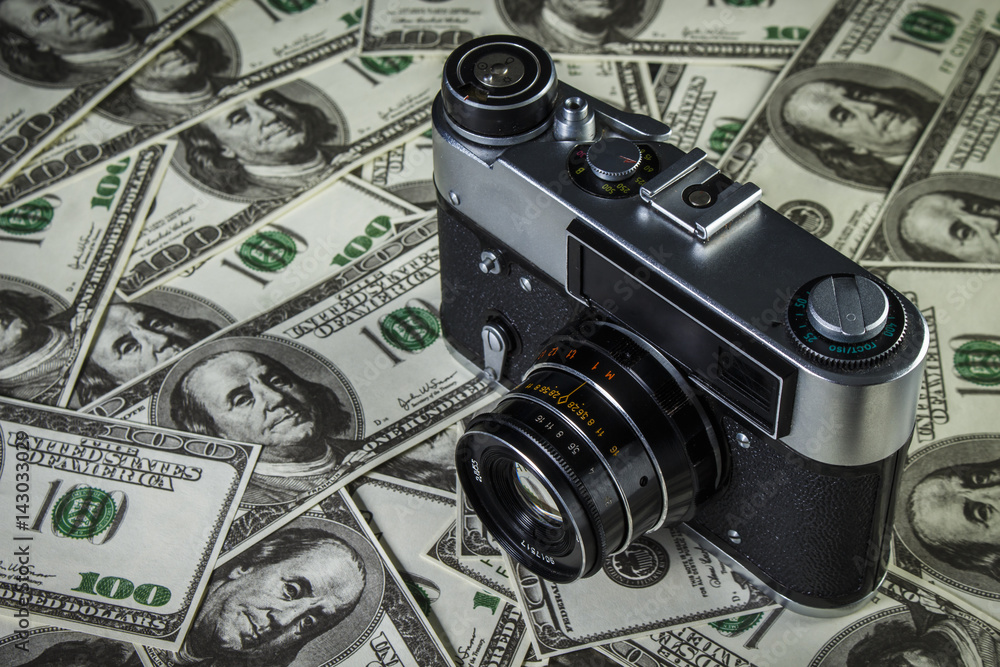 Old Soviet camera on a pile of dollars