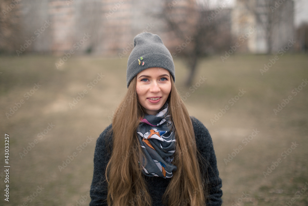 Portrait of a beautiful girl in early spring in a gray cap Portrait of a beautiful girl in early spring in a gray cap
