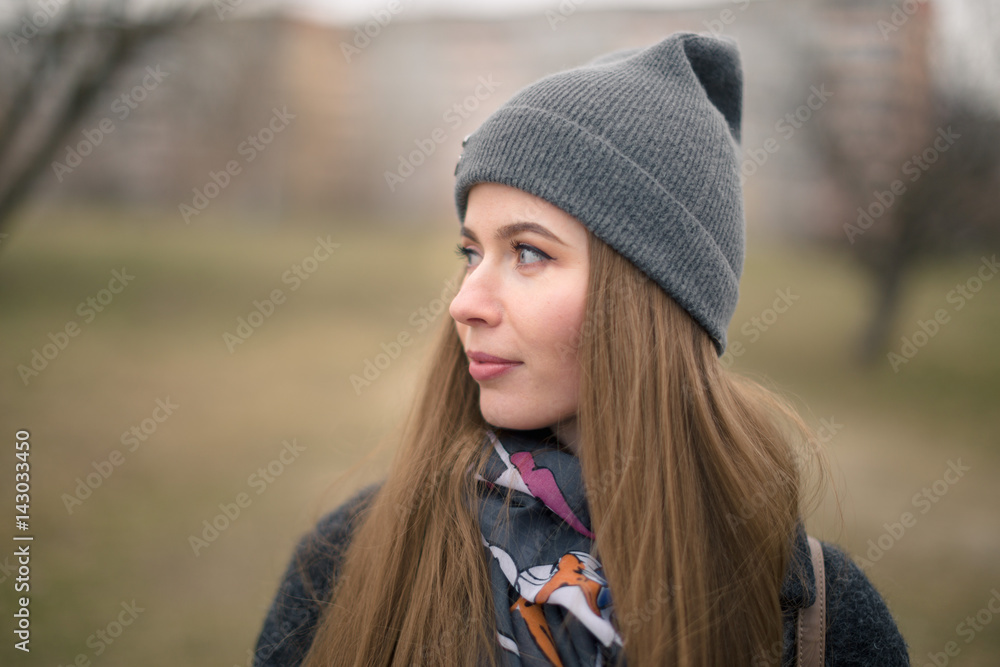 Portrait of a beautiful girl in early spring in a gray cap Portrait of a beautiful girl in early spring in a gray cap