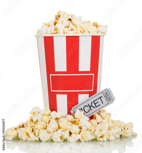Large box full popcorn and popcorn around movie ticket on white.