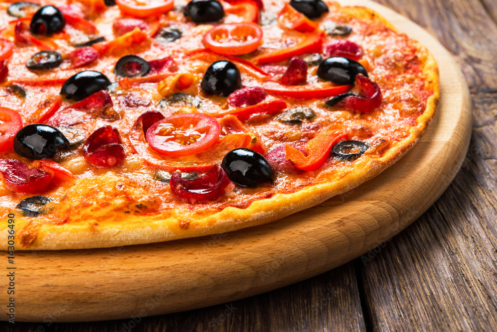 Delicious pizza with salami, mushrooms and olives Delicious pizza with salami, mushrooms and olives