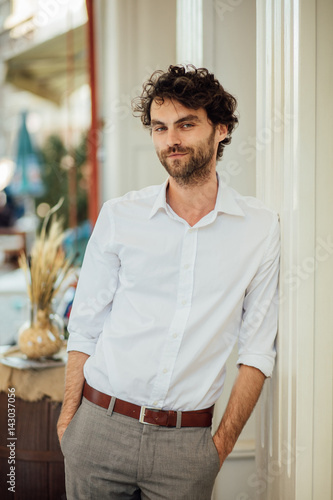 handsome elegant man stanting outside at terrace photo