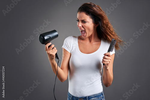 Young woman with a hairdryer 