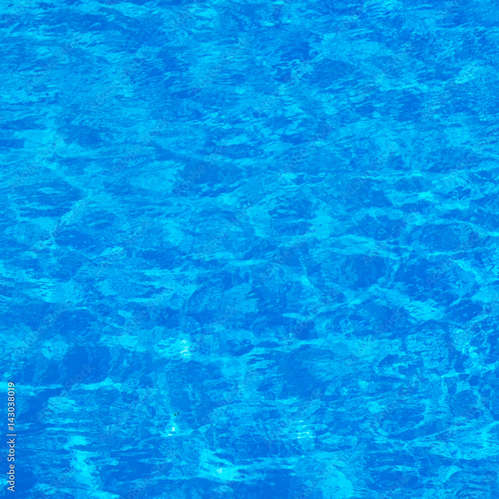 Background of rippled pattern of clean water in a blue swimming pool Background of rippled pattern of clean water in a blue swimming pool