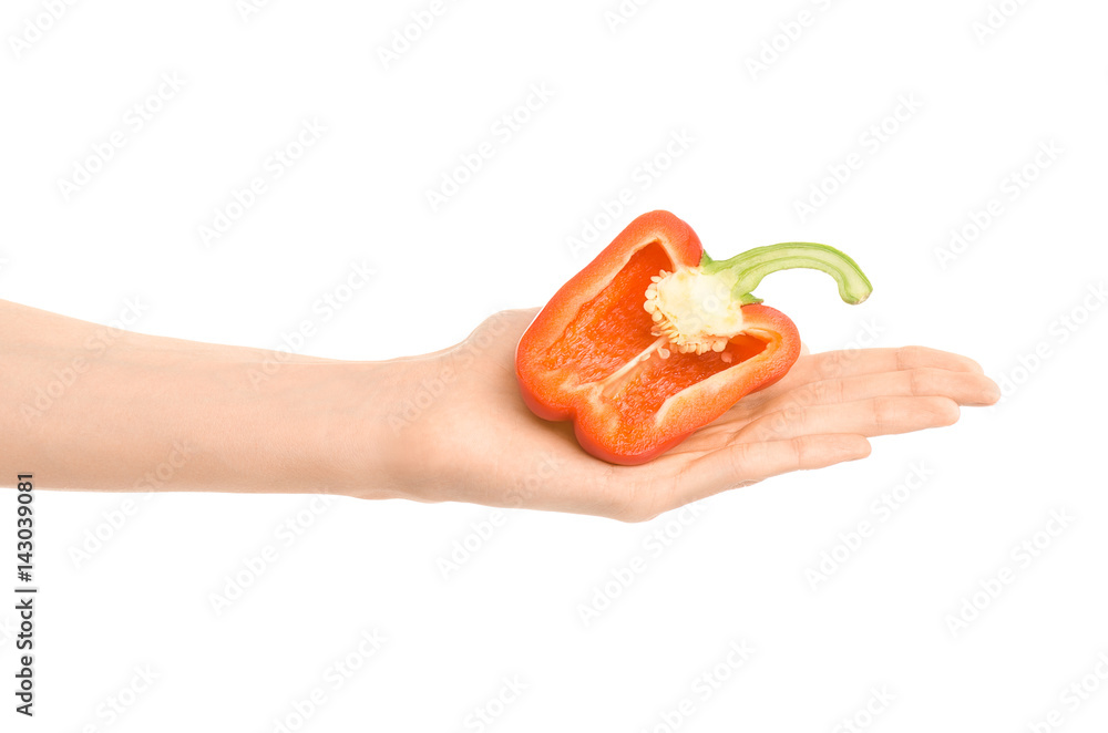 Healthy eating and diet Topic: Human hand holding a half of red pepper isolated on a white background in the studio Healthy eating and diet Topic: Human hand holding a half of red pepper isolated on a white background in the studio
