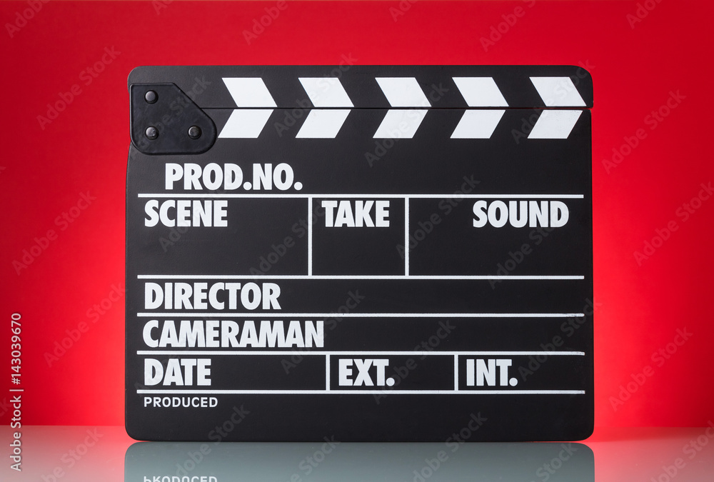 Naklejka premium Black with white letters clapper on bright red background.