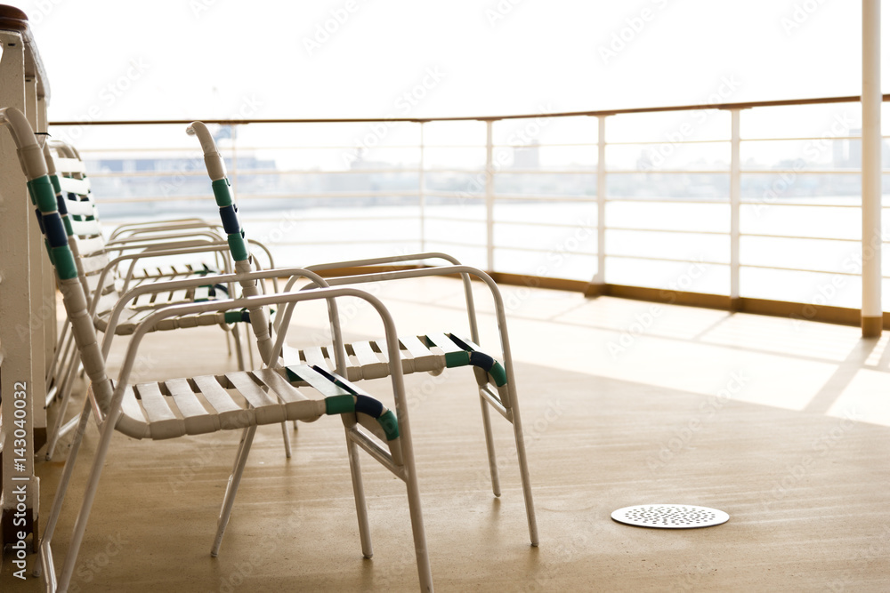 row of sun chairs on the ship deck row of sun chairs on the ship deck