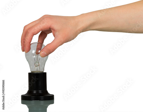 In a female hand an incandescent lamp with cartridge isolated on white background.