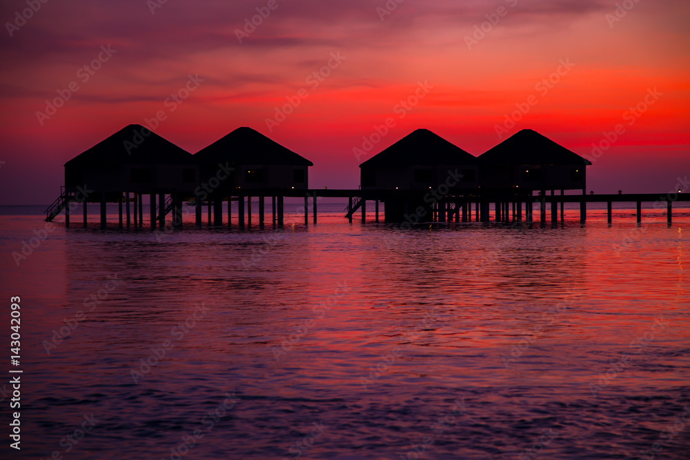 Silhouette of water bungalows at twilight, beautiful landscape Silhouette of water bungalows at twilight, beautiful landscape