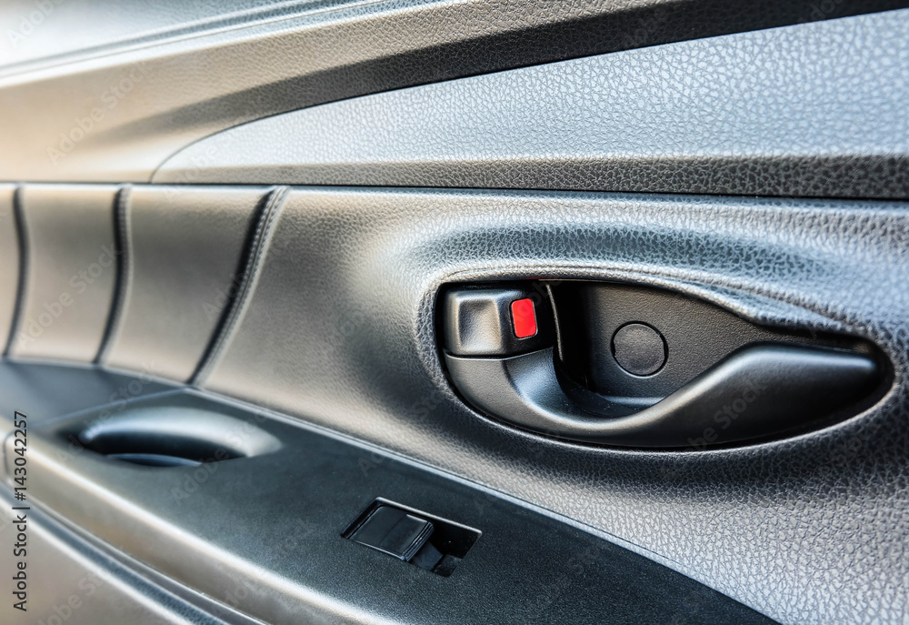 Door handle in car with blurred panel background, close up