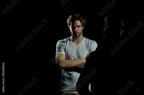Two handsome men standing opposite