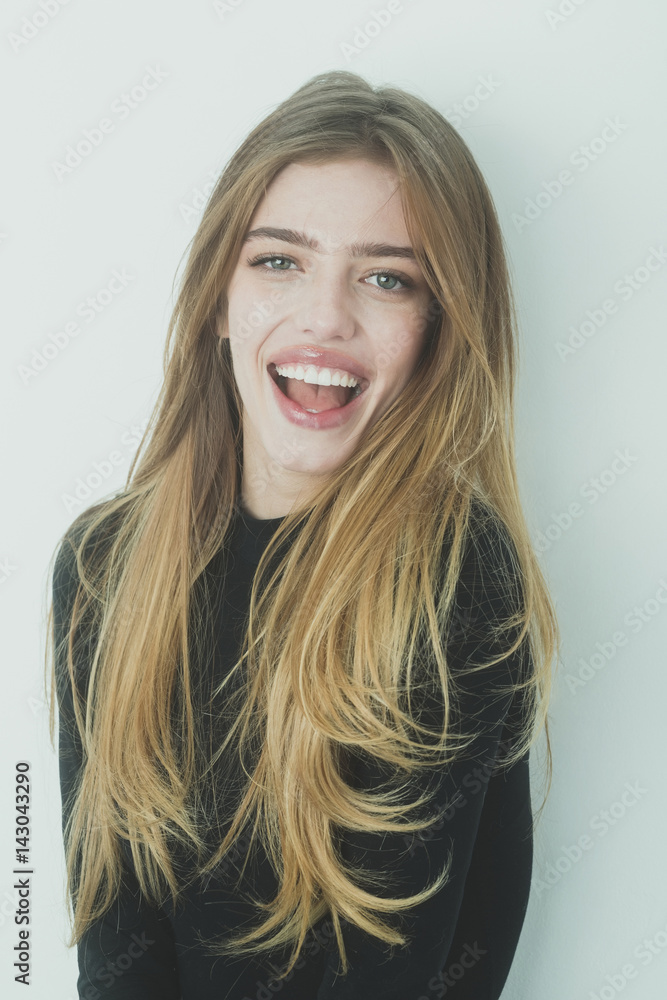 Happy pretty girl with long blond hair in black