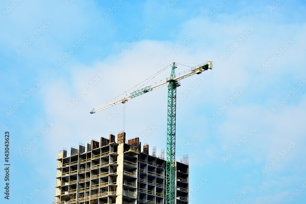 Building site with crane against sky. Construction of new high-rise from concrette and steel. Building site with crane against sky. Construction of new high-rise from concrette and steel.