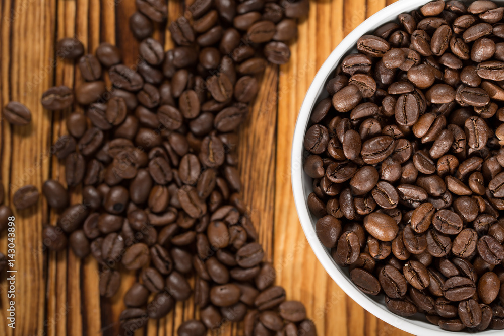 The best beans. The bowl full of roasted coffee beans on a table. The best beans. The bowl full of roasted coffee beans on a table.