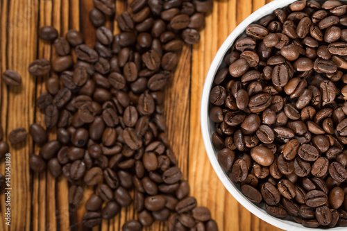 The best beans. The bowl full of roasted coffee beans on a table.