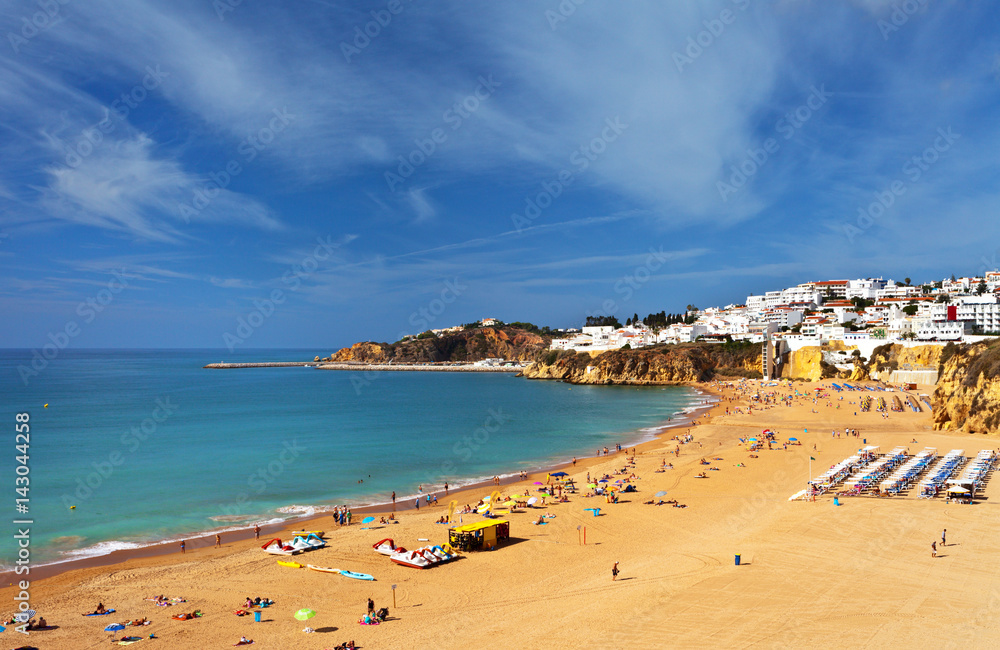 Portugal. Algarve. Old town Albufeira and sandy city beaches. People sunbathe and rest near the sea
