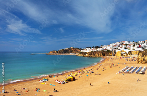 Portugal. Algarve. Old town Albufeira and sandy city beaches. People sunbathe and rest near the sea © Katvic