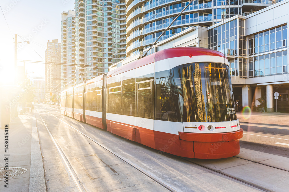 Modern tram in Toronto downtown at sunset