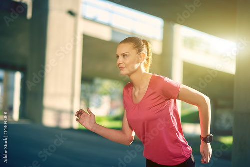 Young woman running side view © nenadaksic