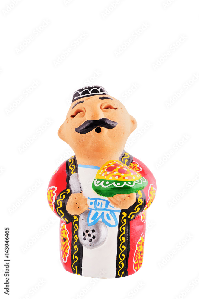 Ceramic statuette of Uzbek man wearing in traditional costume with plate of Uzbekistan pilaf (pilau or local name plow) isolated with work path.