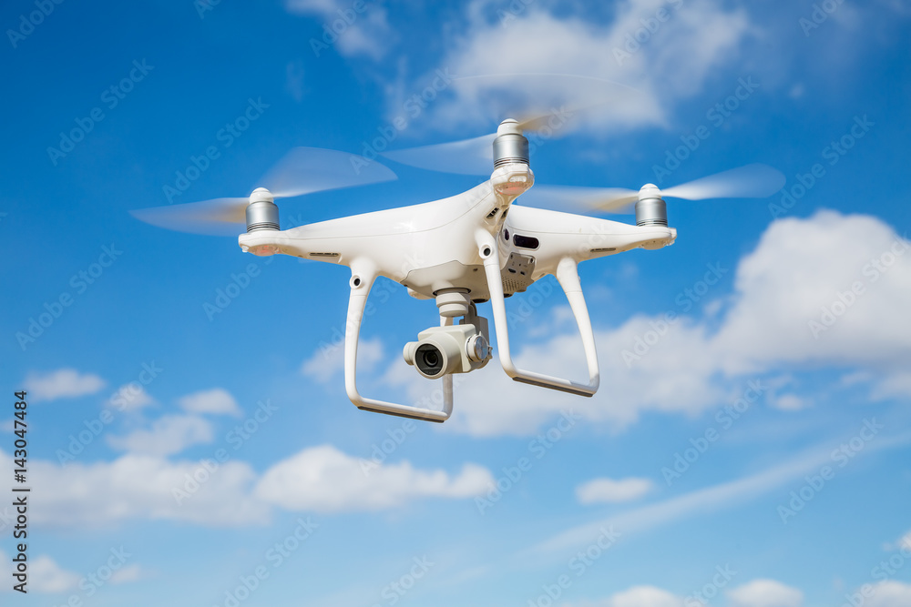 Quadrocopter drone with the camera against the blue sky Quadrocopter drone with the camera against the blue sky