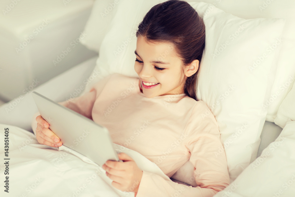 happy girl lying in bed with tablet pc at home happy girl lying in bed with tablet pc at home