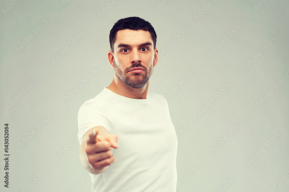 angry man pointing finger to you over gray angry man pointing finger to you over gray