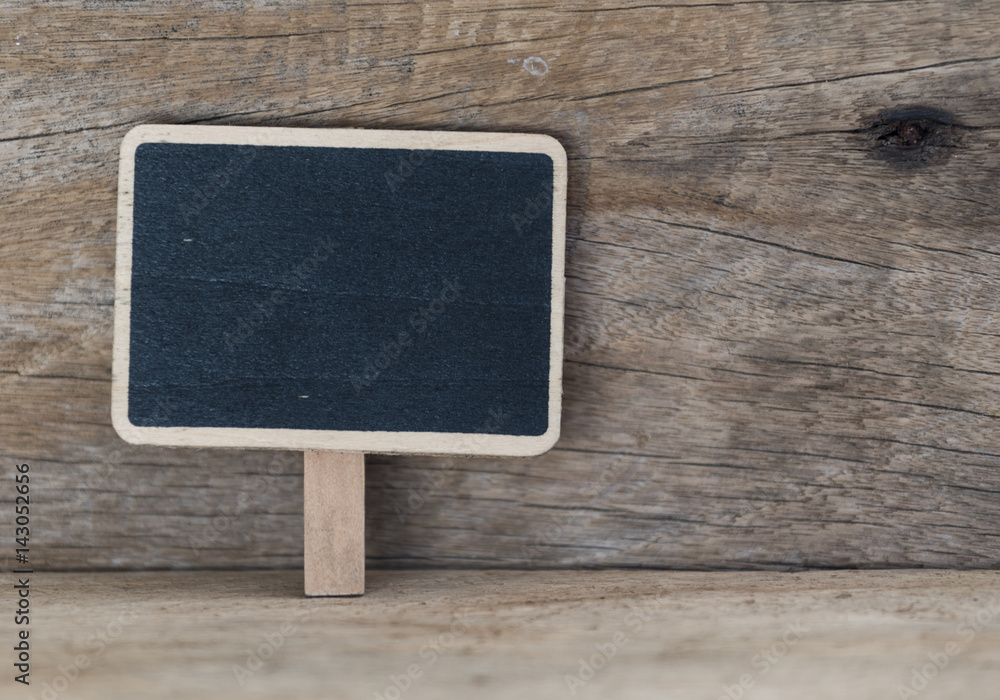 Blank blackboard over grunge wooden table top background Blank blackboard over grunge wooden table top background
