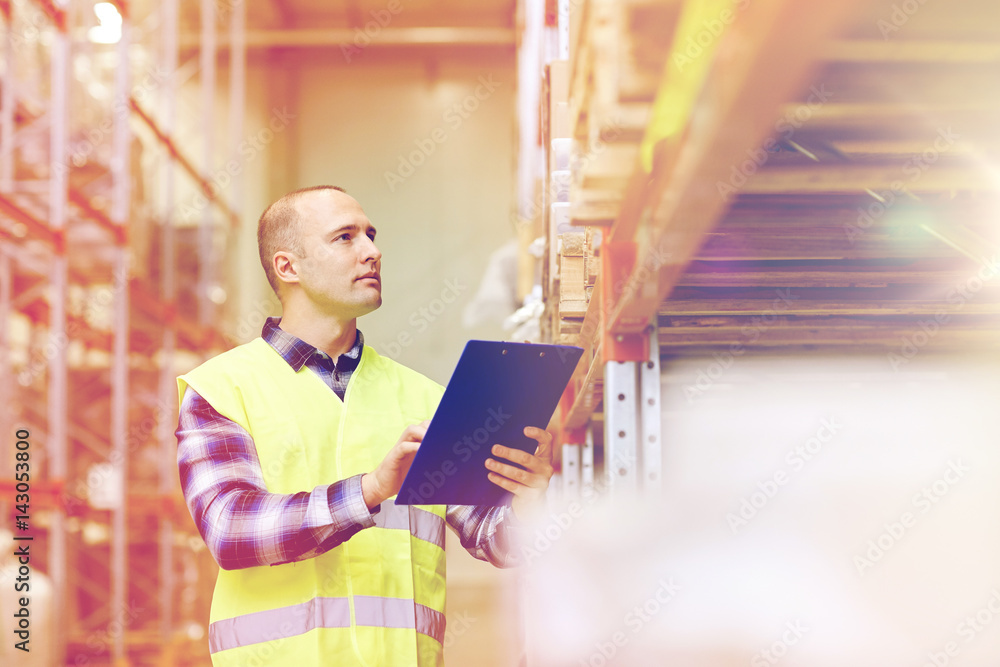 man with clipboard in safety vest at warehouse man with clipboard in safety vest at warehouse