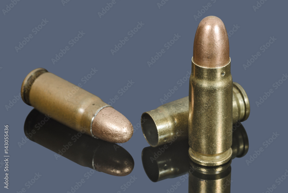 Pistol cartridges of caliber 7.62 mm on gray background Pistol cartridges of caliber 7.62 mm on gray background