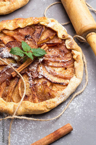 Biscuits with apples, cinnamon and ginger, mint on a gray background. photo