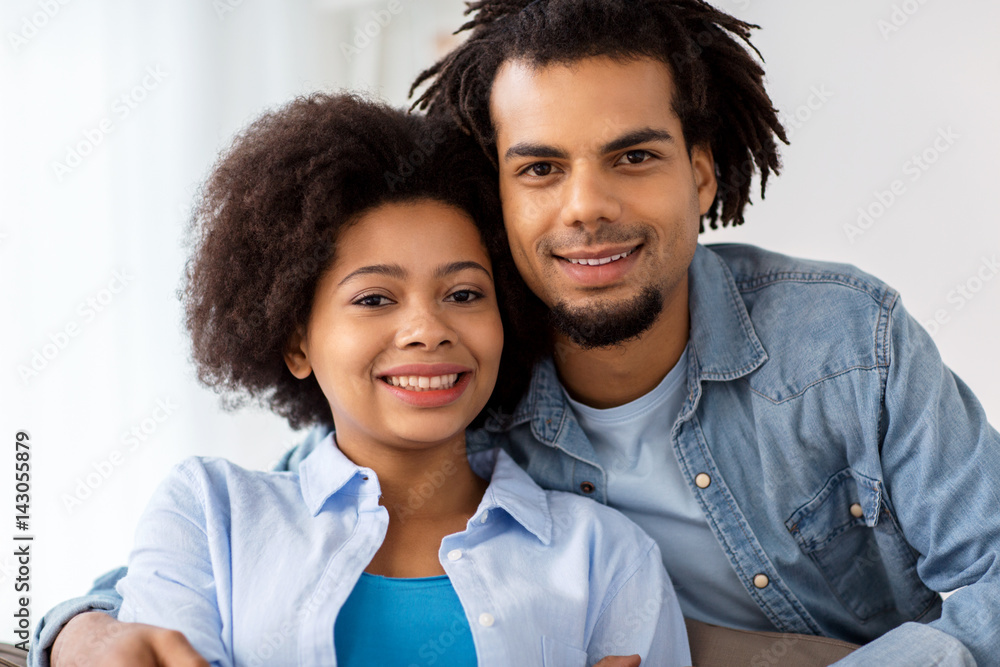 happy couple sitting on sofa and hugging at home happy couple sitting on sofa and hugging at home
